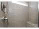 Bright, tiled shower boasts a built-in bench and features a convenient, adjustable shower head at 110 Synandra Dr # B, Mooresville, NC 28117