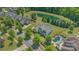 Aerial view of property showcasing pool, lush landscaping, and proximity to pond at 11333 Preservation Ln, Charlotte, NC 28278