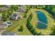 Drone shot of a house with a pool, manicured lawn, pond, deck, and solar panels, offering a luxurious outdoor space at 11333 Preservation Ln, Charlotte, NC 28278
