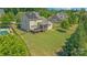 Large backyard featuring a deck, screened porch, fence, lush greenery, and solar panels on the roof at 11333 Preservation Ln, Charlotte, NC 28278