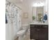 Neutral toned bathroom with a vanity, framed mirror, and shower featuring a decorative curtain at 11333 Preservation Ln, Charlotte, NC 28278