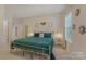 Inviting bedroom showcasing a gold-framed bed with blue bedding, side tables and soft lighting at 11333 Preservation Ln, Charlotte, NC 28278