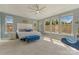 Bright bedroom with many windows, a ceiling fan, and a sitting area at 11333 Preservation Ln, Charlotte, NC 28278