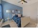 A bedroom featuring blue accents, a queen sized bed, and soft lighting from a bedside lamp at 11333 Preservation Ln, Charlotte, NC 28278