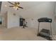 Spacious bonus room with exercise bike, treadmill, and ample storage in neutral tones at 11333 Preservation Ln, Charlotte, NC 28278