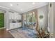 Bright breakfast nook featuring white cabinets, access to the patio, and stylish decor at 11333 Preservation Ln, Charlotte, NC 28278