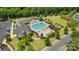 Aerial view of the community pool and clubhouse, featuring playground and manicured grounds at 11333 Preservation Ln, Charlotte, NC 28278