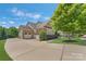 Beautiful home with spacious driveway and multi-car garage nestled on a manicured lawn at 11333 Preservation Ln, Charlotte, NC 28278