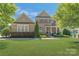 Charming two-story brick home with manicured lawn and inviting front porch at 11333 Preservation Ln, Charlotte, NC 28278