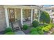 Charming covered front porch with decorative columns and manicured landscaping at 11333 Preservation Ln, Charlotte, NC 28278