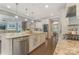 Gourmet kitchen with granite counters, stainless appliances, and open layout to the living area at 11333 Preservation Ln, Charlotte, NC 28278