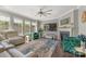 Bright living room featuring a fireplace, large windows, comfortable seating, and stylish decor at 11333 Preservation Ln, Charlotte, NC 28278