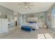 Spacious main bedroom featuring plush carpeting, decorative mirrors and large windows at 11333 Preservation Ln, Charlotte, NC 28278