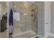 Glass enclosed shower with tile surround and built-in bench at 11333 Preservation Ln, Charlotte, NC 28278