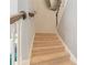 Carpeted staircase with white banister and wood handrail at 11333 Preservation Ln, Charlotte, NC 28278
