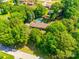 Aerial view of a property with a pool and lush green landscaping at 1154 Doby Ct, Fort Mill, SC 29715