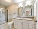 Bright bathroom features double vanity with granite counters and a glass-enclosed shower at 1154 Doby Ct, Fort Mill, SC 29715