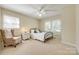 Bedroom features neutral carpet, ample natural light, and a ceiling fan at 1154 Doby Ct, Fort Mill, SC 29715
