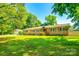 Sprawling front yard and brick home exterior with lots of shade in this residential neighborhood at 1154 Doby Ct, Fort Mill, SC 29715