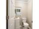 Clean half bath featuring a sleek vanity, toilet, and fresh white paint at 1154 Doby Ct, Fort Mill, SC 29715