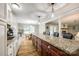 Bright kitchen features granite counters, a center island, and a sunlit dining area at 1154 Doby Ct, Fort Mill, SC 29715