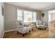 Sitting area with neutral paint, two patterned chairs, and natural light from the window at 1154 Doby Ct, Fort Mill, SC 29715