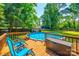 Inviting backyard features an in-ground pool, wooden deck, and lounge chairs surrounded by lush greenery at 1154 Doby Ct, Fort Mill, SC 29715
