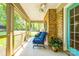 Screened porch with brick accent wall, seating, and a ceiling fan at 1154 Doby Ct, Fort Mill, SC 29715