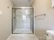 Walk-in shower with glass doors, tiled walls, and chrome fixtures at 1154 Doby Ct, Fort Mill, SC 29715