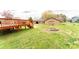 A spacious green backyard with a fire pit, a deck, and an outbuilding at 125 Southwood Park, Mooresville, NC 28117