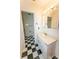 Bathroom featuring a black and white tile floor, a white vanity, and a combined tub and shower at 125 Southwood Park, Mooresville, NC 28117