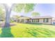 Charming brick home featuring a well-manicured lawn and mature shade tree at 125 Southwood Park, Mooresville, NC 28117