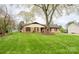 Brick home with a large front lawn and a mature shade tree at 125 Southwood Park, Mooresville, NC 28117
