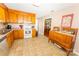 Kitchen with classic wooden cabinetry, neutral countertops, and tile flooring at 125 Southwood Park, Mooresville, NC 28117