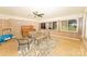 Bright living room featuring ample windows, brick wall accents, ceiling fan and a piano at 125 Southwood Park, Mooresville, NC 28117
