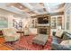 Elegant living room with stone fireplace, built-in shelving and coffered ceiling with recessed lighting at 1260 Rittenhouse Ln, Rock Hill, SC 29732