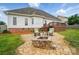 Backyard features a stone patio, fire pit, and access to a wooden deck at 129 Daniel Efird Dr, Mount Holly, NC 28120