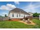 A backyard with a stone patio and access to a wooden deck at 129 Daniel Efird Dr, Mount Holly, NC 28120