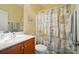 Traditional bathroom features a wood vanity, patterned shower curtain and neutral walls at 129 Daniel Efird Dr, Mount Holly, NC 28120