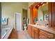 Bathroom featuring a wood vanity with decorative mirror, soaking tub, and tile flooring at 129 Daniel Efird Dr, Mount Holly, NC 28120