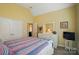 Comfortable bedroom features a queen bed, neutral walls, and ample closet space at 129 Daniel Efird Dr, Mount Holly, NC 28120