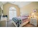 Bedroom with vaulted ceilings, large arched window, and comfortable furnishings at 129 Daniel Efird Dr, Mount Holly, NC 28120