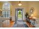 Inviting foyer with hardwood floors, decorative rug, and sunburst mirror at 129 Daniel Efird Dr, Mount Holly, NC 28120