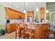 Kitchen featuring breakfast bar with wooden chairs, pendant lighting, and modern appliances at 129 Daniel Efird Dr, Mount Holly, NC 28120