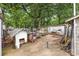 Backyard area featuring mature trees and a variety of items stored behind a garage at 1308 Edgewood Rd, Charlotte, NC 28208
