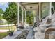 Inviting covered front porch with seating and decorative plants at 1308 Edgewood Rd, Charlotte, NC 28208