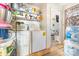 Practical laundry area with washer, dryer, and storage shelves at 1308 Edgewood Rd, Charlotte, NC 28208