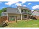 Spacious backyard features a manicured lawn, garden, and patio area perfect for entertaining guests at 13430 Norseman Ln, Huntersville, NC 28078