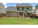 Expansive backyard featuring a patio, well-manicured lawn, and relaxing seating area at 13430 Norseman Ln, Huntersville, NC 28078