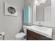 Powder room with toilet, sink, and charming wall decor for a welcoming ambiance at 13430 Norseman Ln, Huntersville, NC 28078